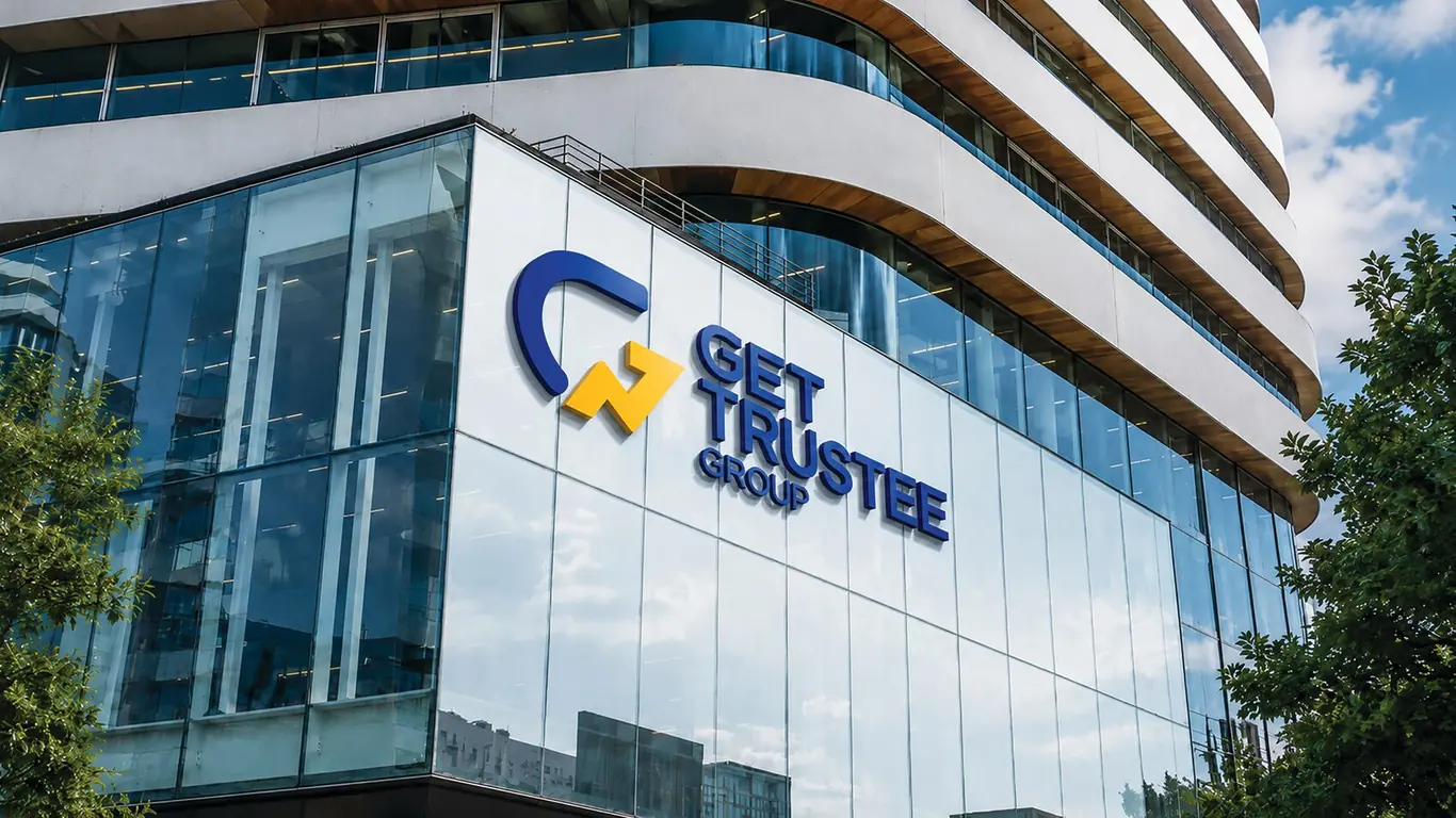 GET Trustee Group outdoor signage in raised lettering across a glass office building facade