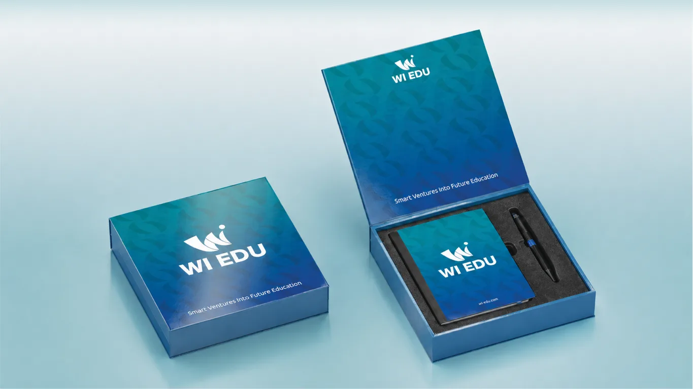 WI Edu corporate gift box shown closed and open with a branded notebook and pen