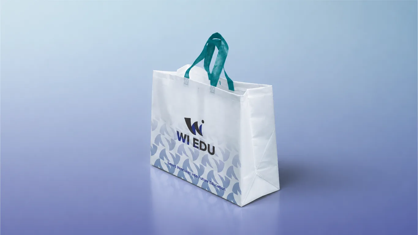 White WI Edu tote bag with teal handles, logo, tagline and repeating W graphic