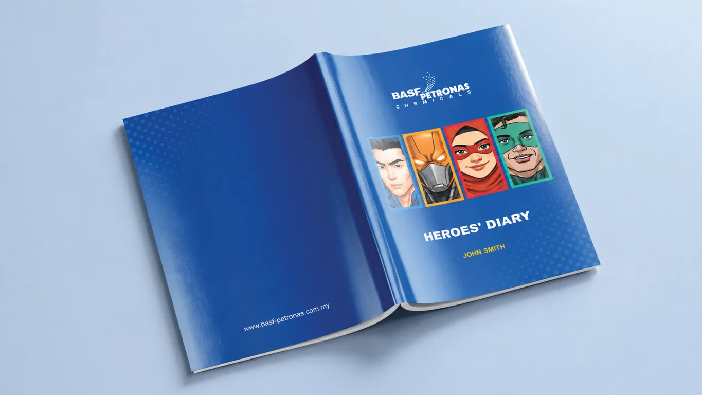 BASF Malaysia Heroes' Diary opened flat, blue cover carrying four superhero portraits and a personalised name