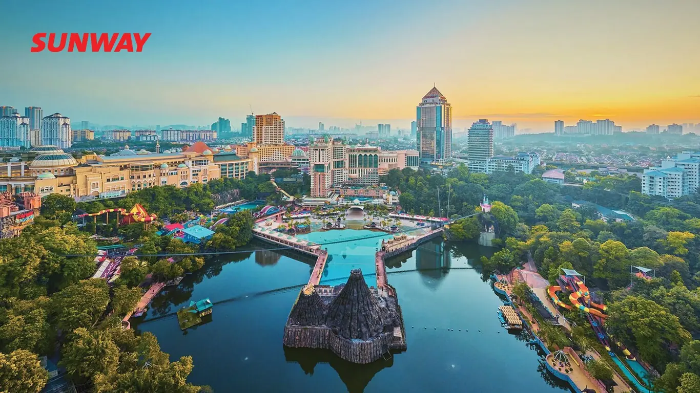 Sunway Berhad logo over an aerial cityscape of lake, theme park, mall and tower blocks
